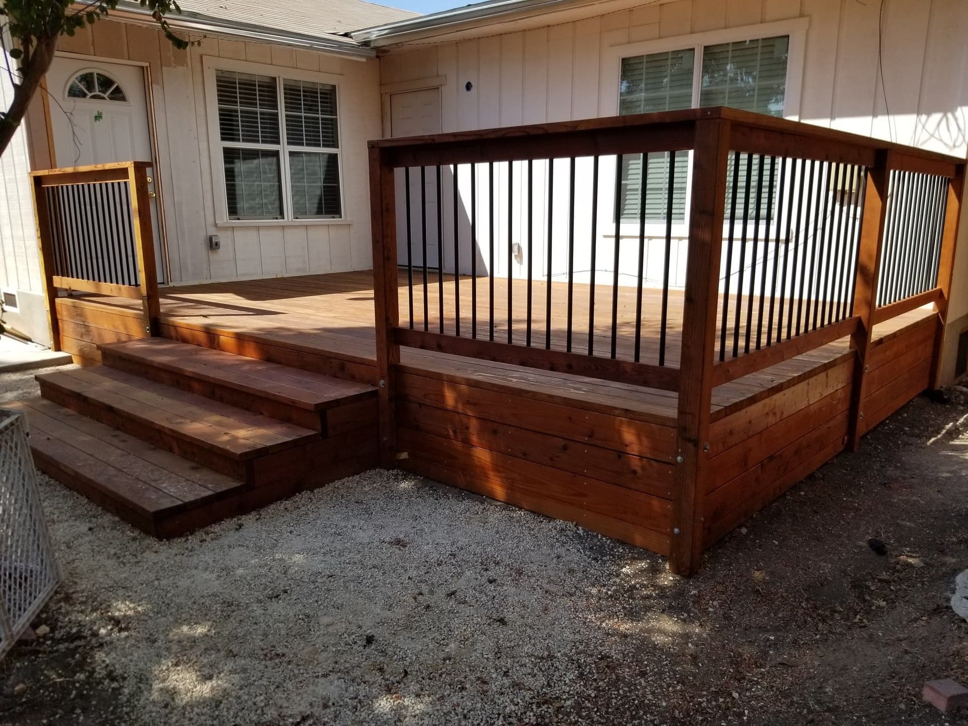 Finished redwood deck with black metal railing