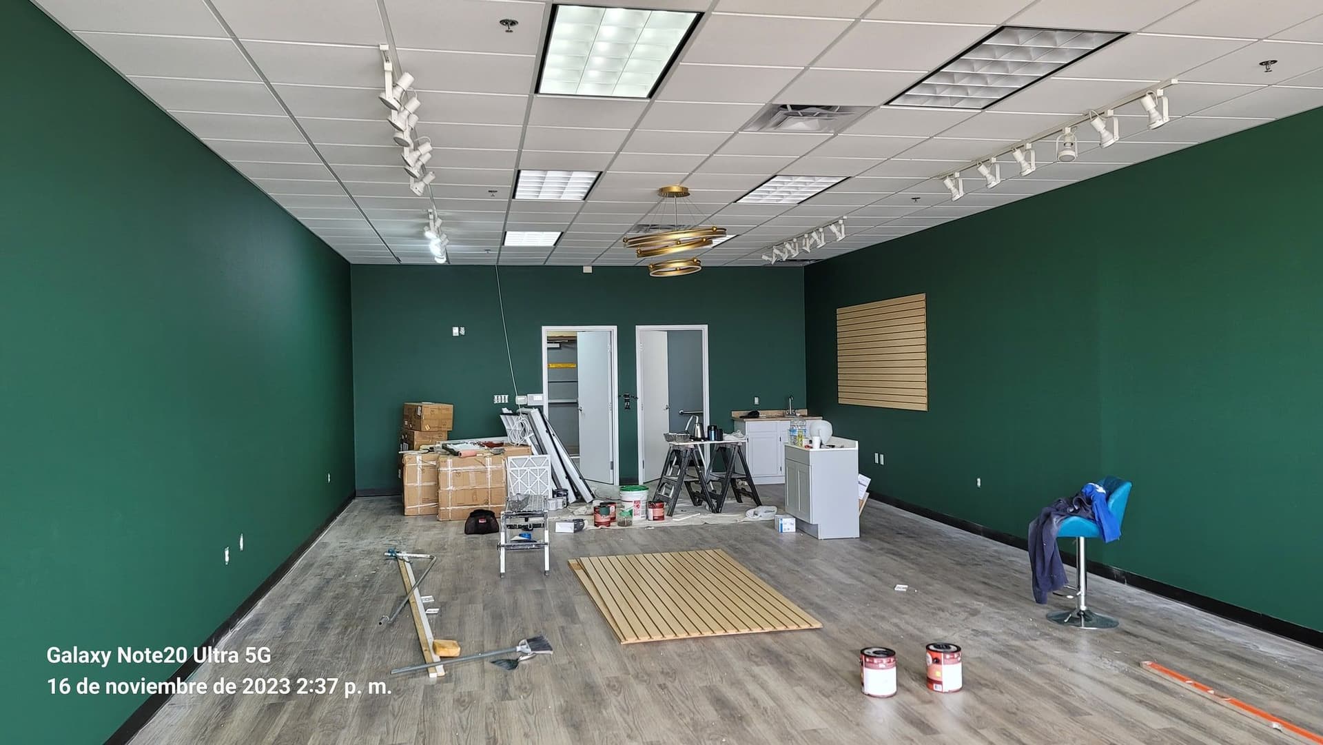 Interior with green walls and plank flooring being laid